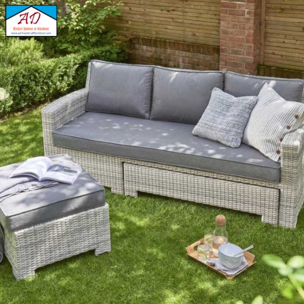 An outdoor wicker sofa set with a high backrest